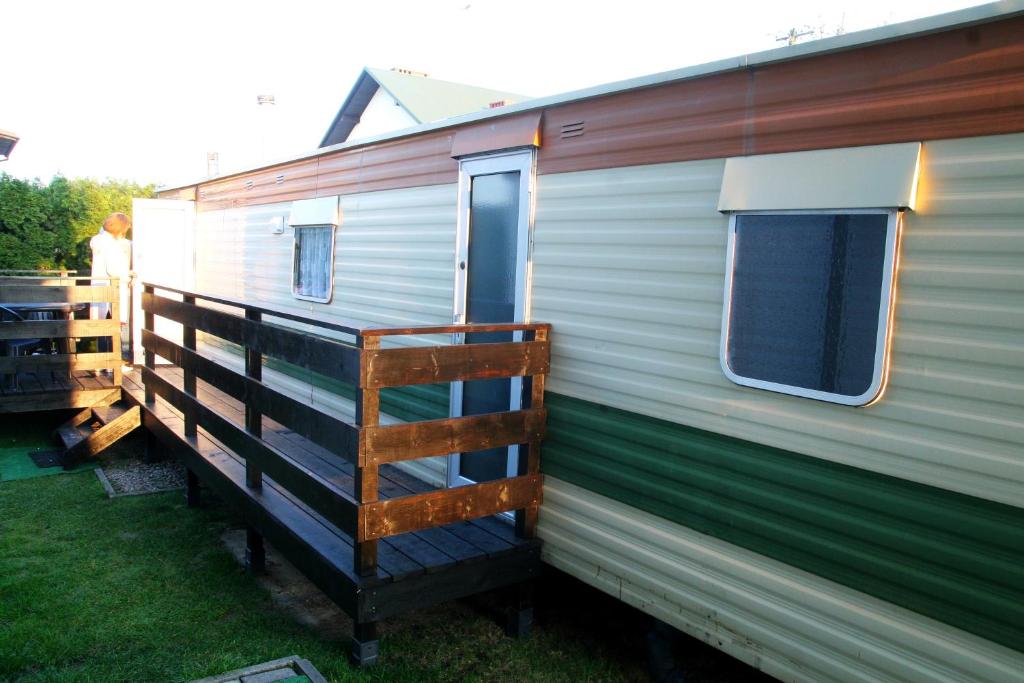 a green and white trailer with a ladder on it at Noclegi u Jagny in Zator