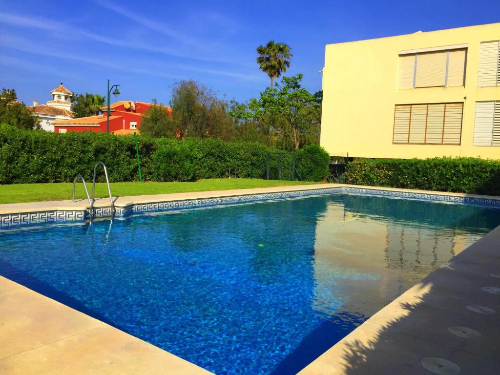 a swimming pool in front of a house at Apartamento Chay in Málaga