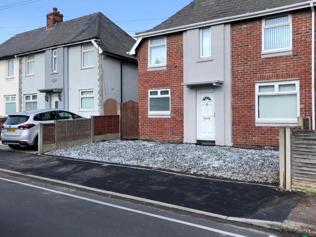 a house with a gravel driveway in front of it at Blackpool Entire holiday home - LEAVESLEY in Blackpool