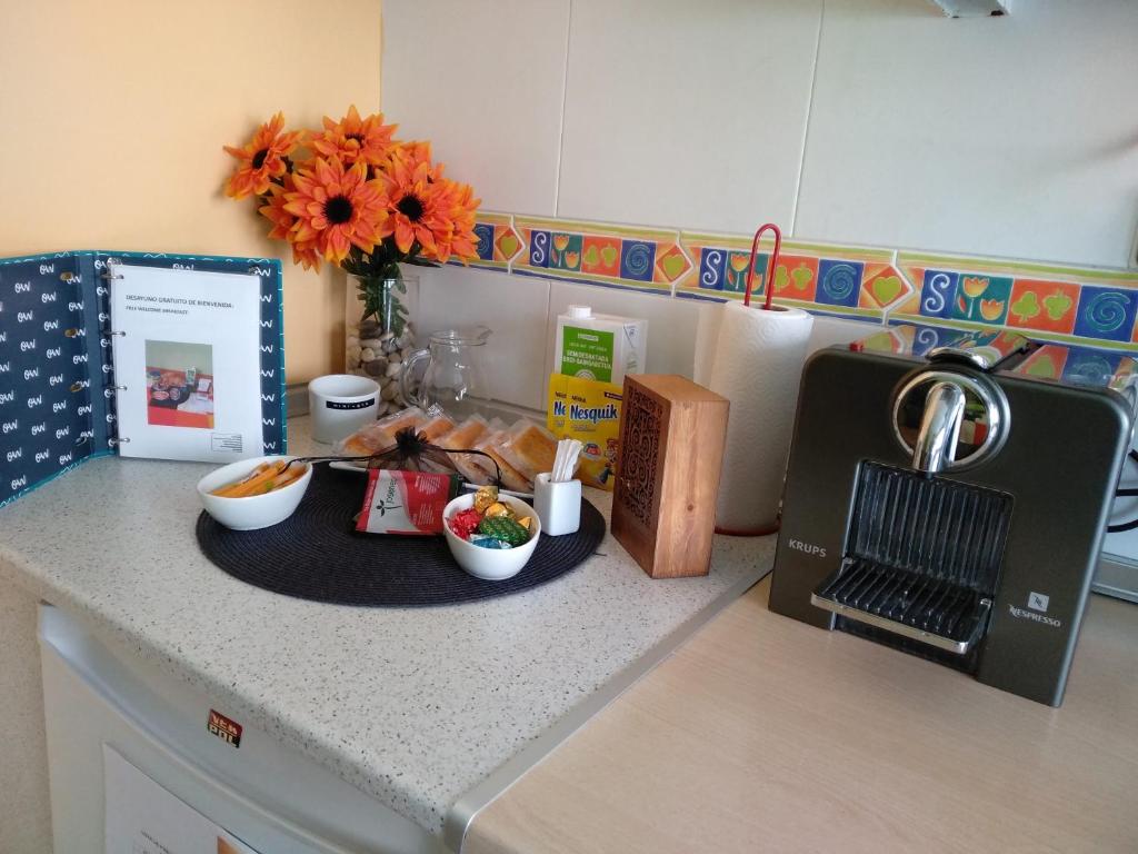 a kitchen counter with bowls of food and a sink at Vianatxiki in Viana