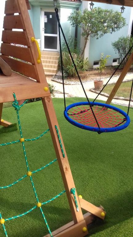 a swing set in a yard with at Villa Verde Apartments and Rooms in Premantura