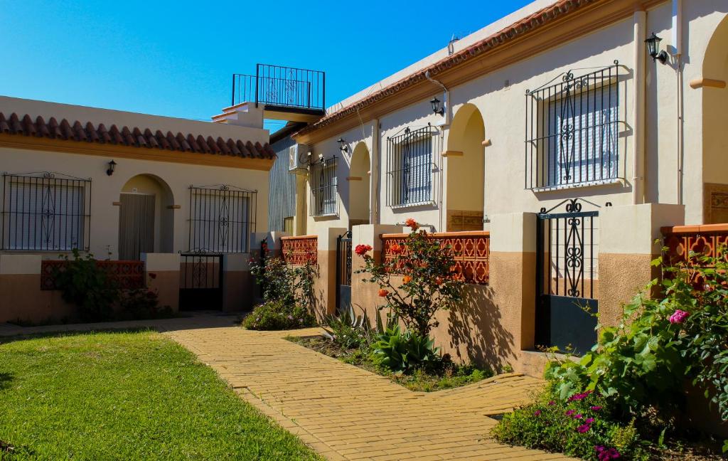 a house with a pathway in front of it at Apartamentos Bellavista Bolonia in Bolonia