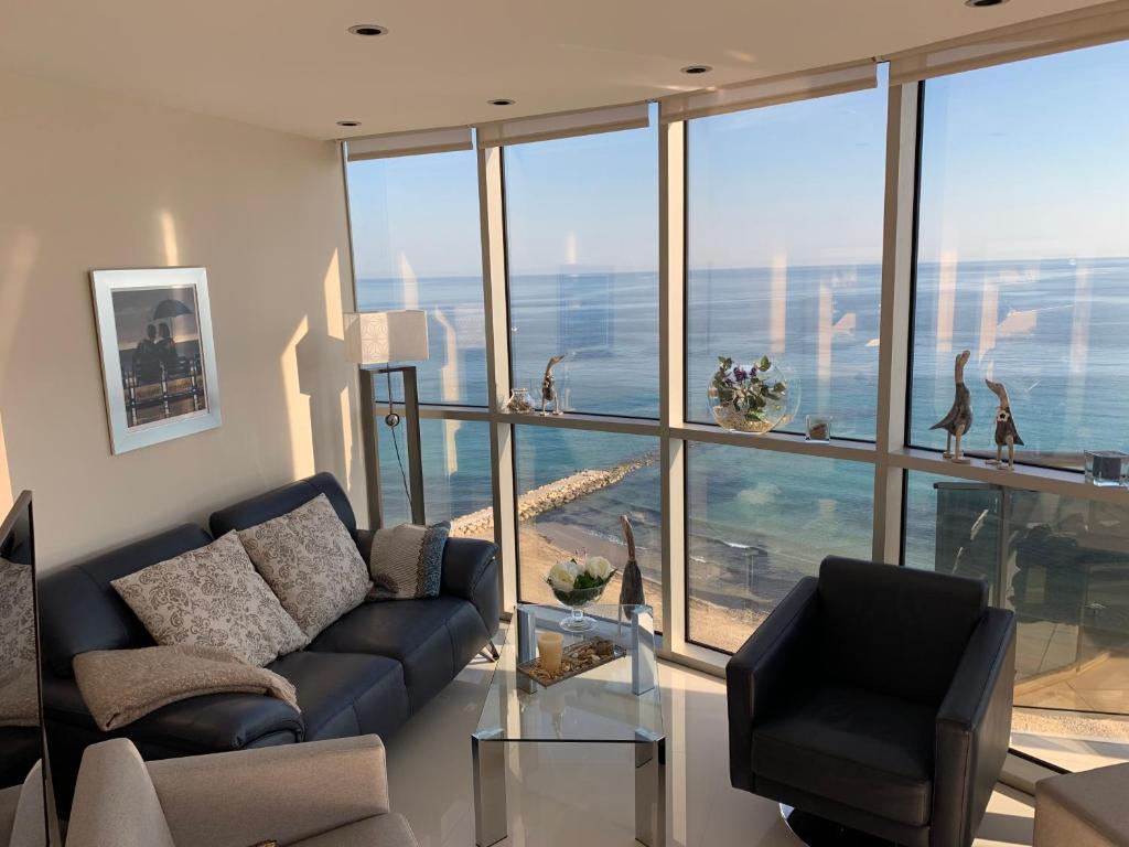 a living room with a couch and a large window at Apartment Vista Bella in Calpe