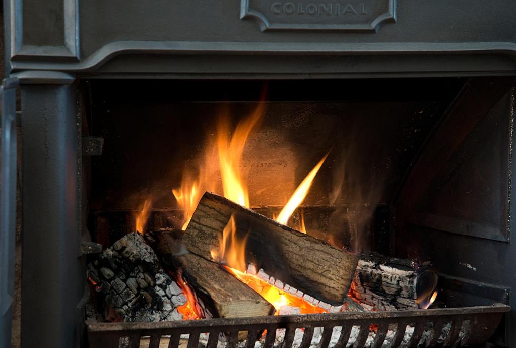 a fire in an oven with flames in it at The Jug And Bottle in Heswall