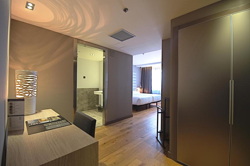 a living room with a room with a bed and a desk at Zenit Vigo in Vigo