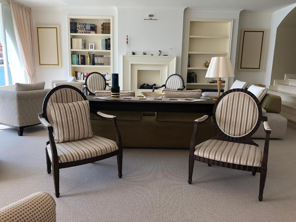 a living room with a large desk with chairs at Hotel Miramare & Spa in Sestri Levante