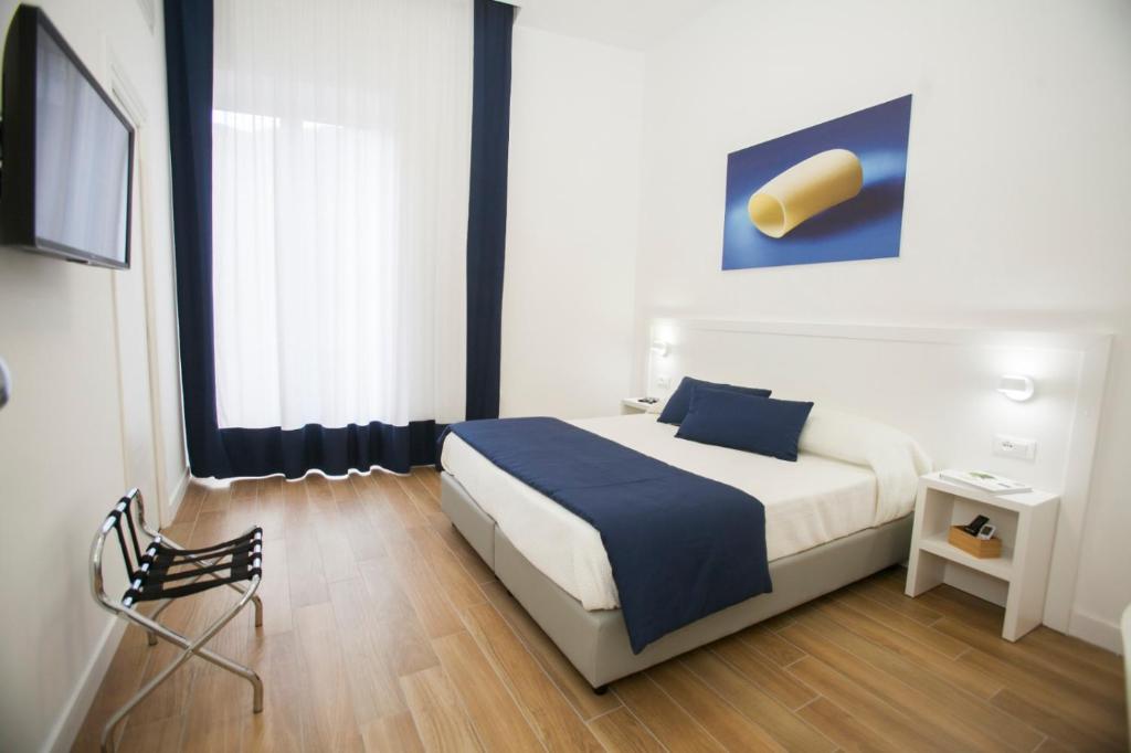 una camera con un letto e una coperta blu di Mediterranean rooms a Castellammare di Stabia