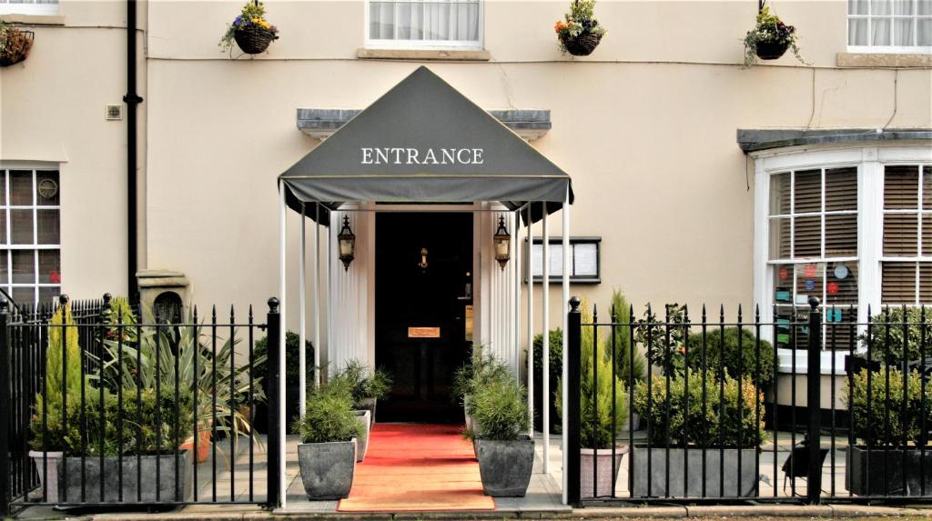 a black awning over the entrance to a building at Le Bouchon Brasserie & Hotel in Maldon