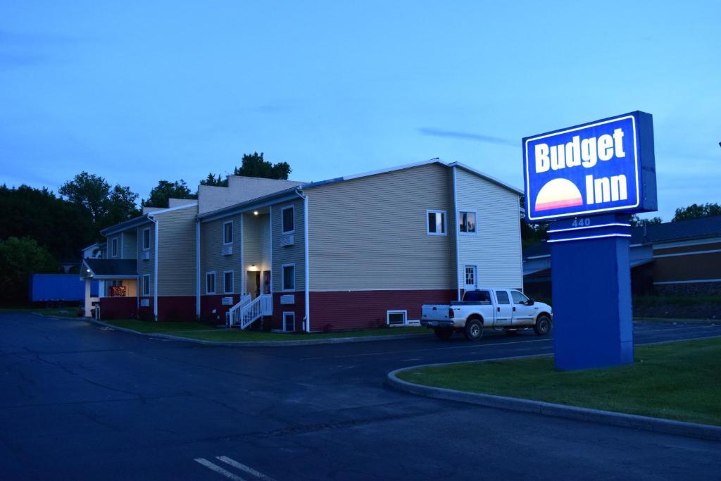 a building with aurger inn sign in front of a building at Budget Inn Ontario in Ontario Center