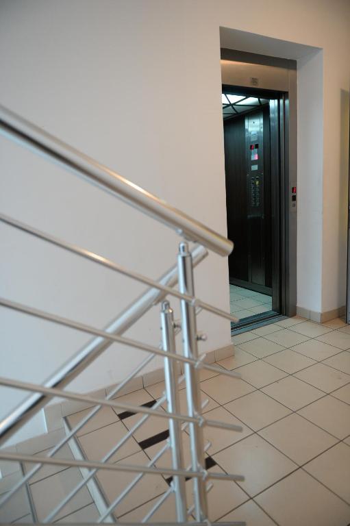 a staircase in an office building with a door at Apartman SUN in Inđija