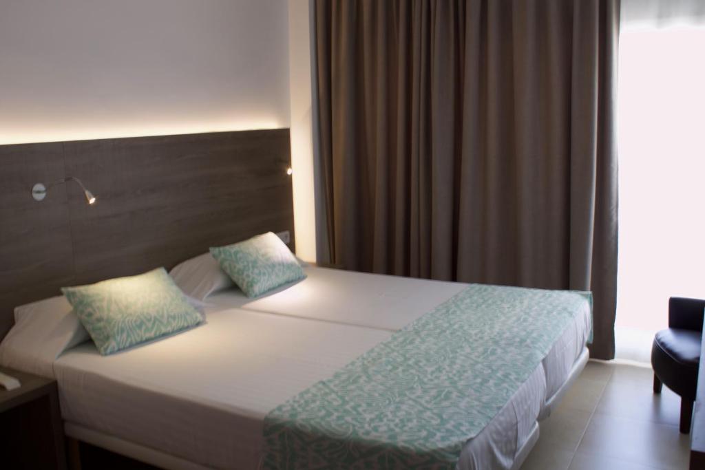 Postel nebo postele na pokoji v ubytování Hotel Vista Odin