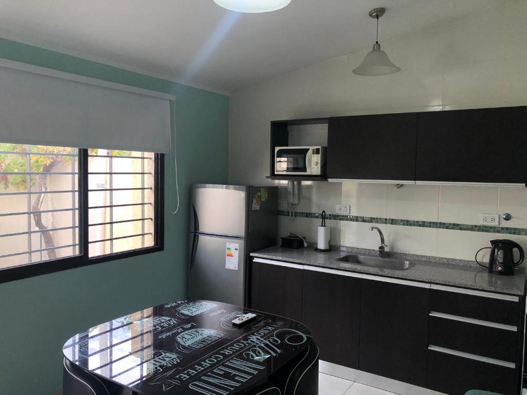 a small kitchen with a table and a refrigerator at Santa Rita in San Rafael