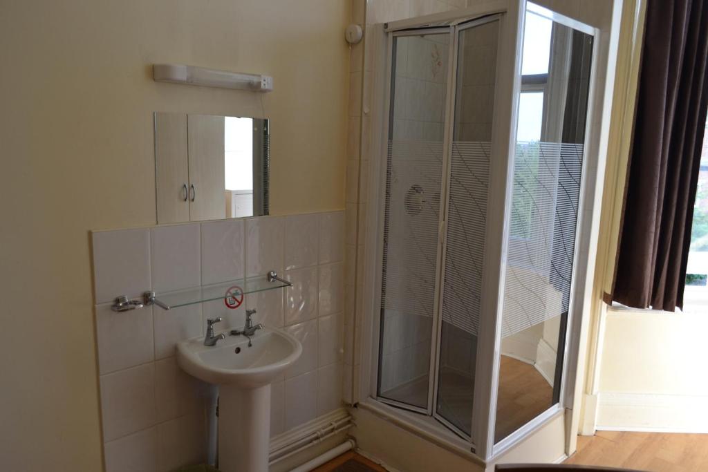 a bathroom with a shower and a sink at Croft Hotel in Leicester