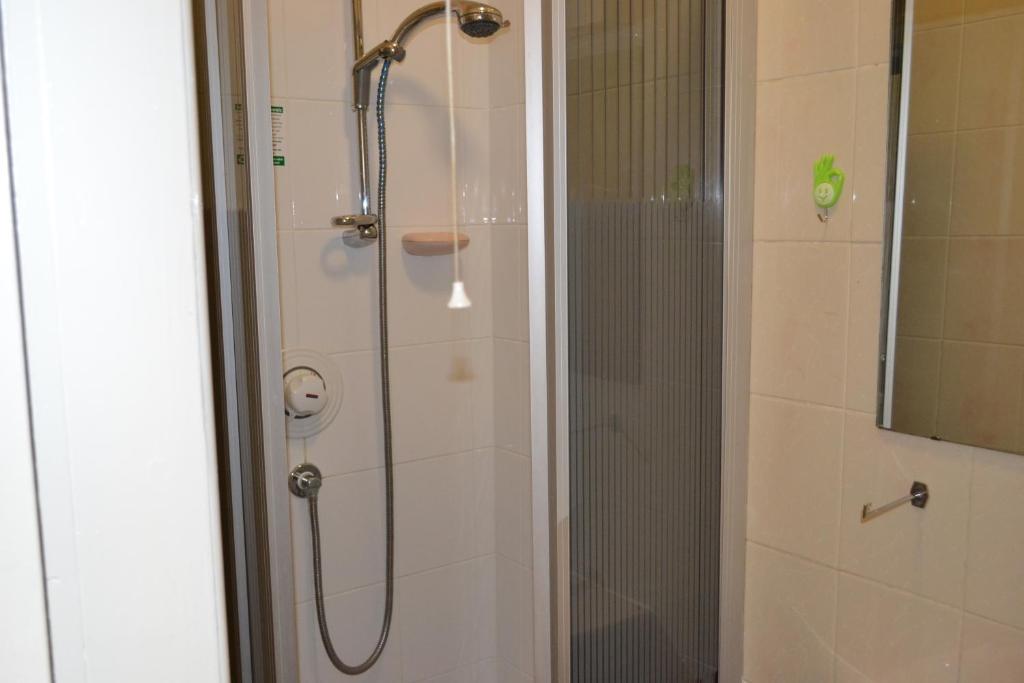 a shower in a bathroom with a glass door at Croft Hotel in Leicester