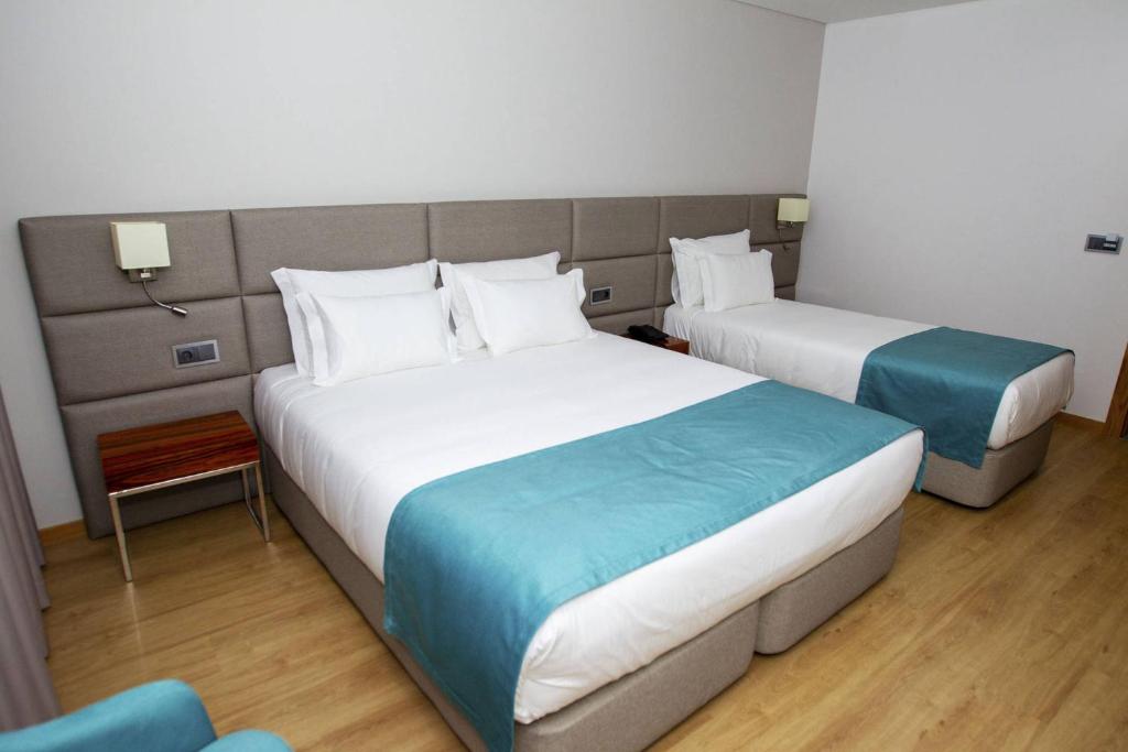 Postel nebo postele na pokoji v ubytování Hotel Fafense