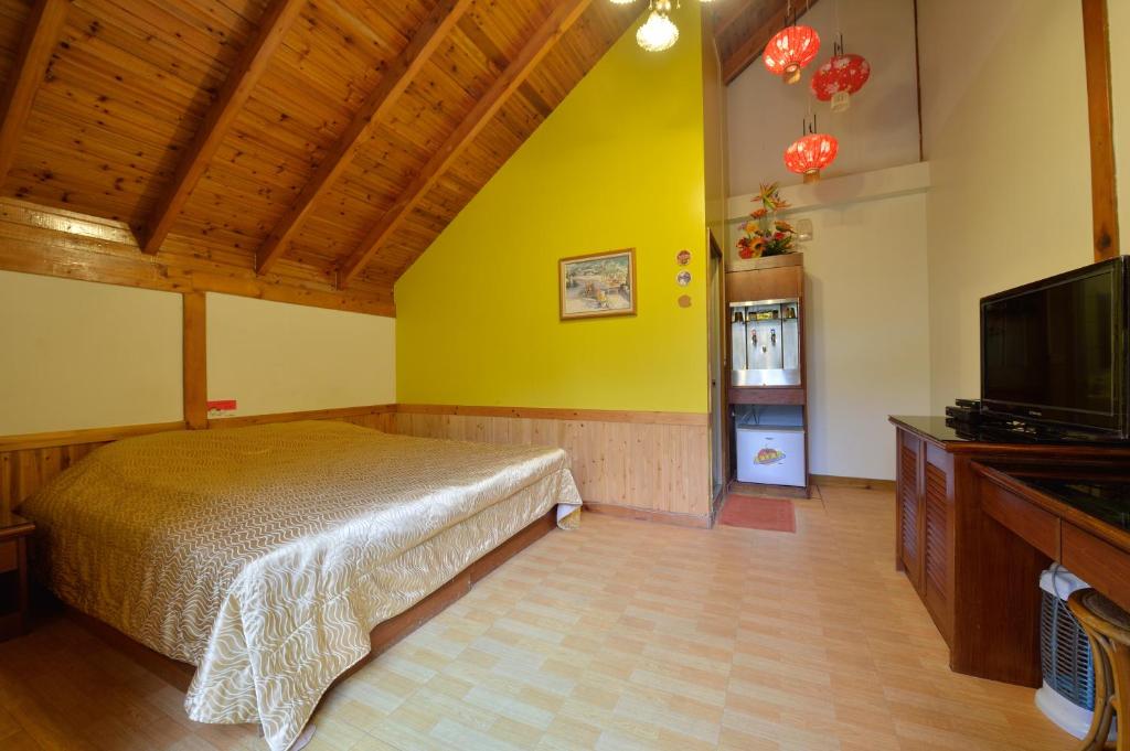 Postel nebo postele na pokoji v ubytování Shinmingshan Holiday Inn