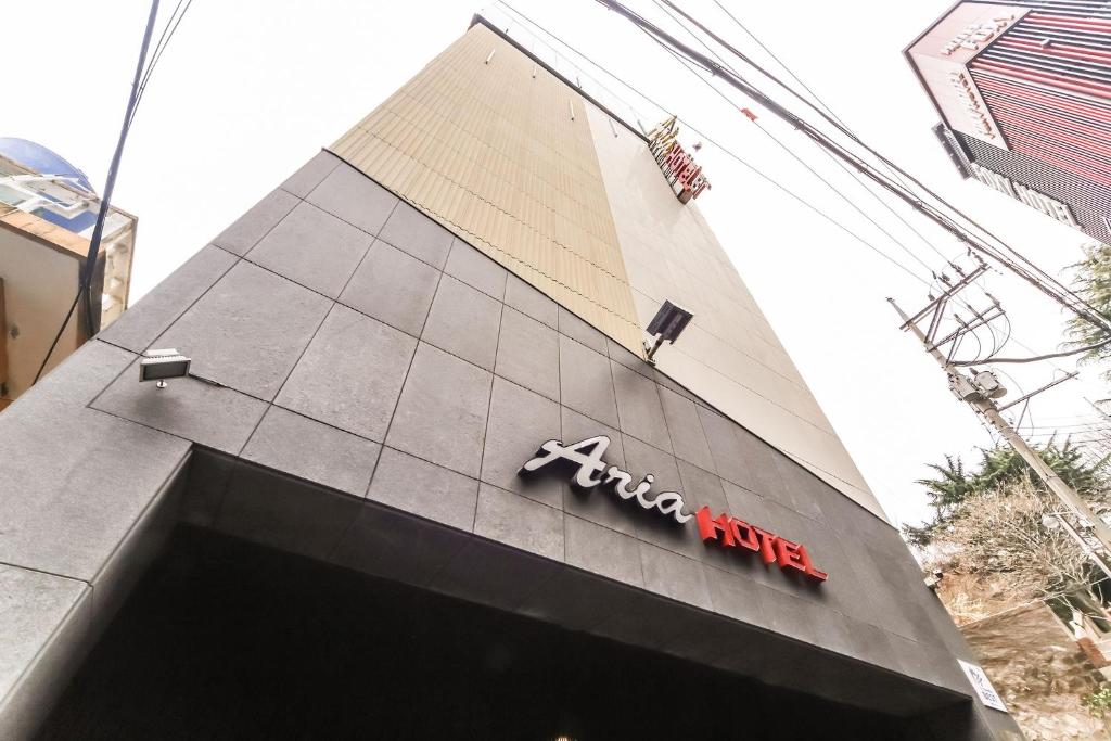 a building with a sign on the side of it at Boutique Hotel Aria Nampo in Busan