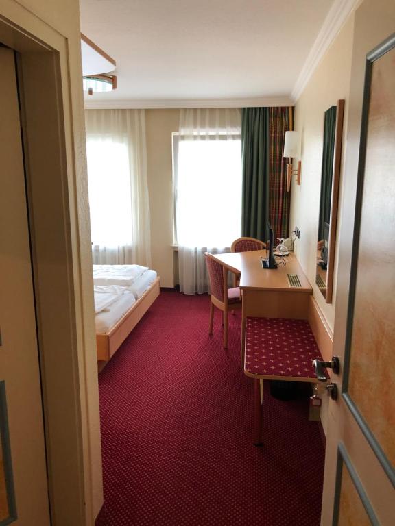 Postel nebo postele na pokoji v ubytování Hotel Pflieger