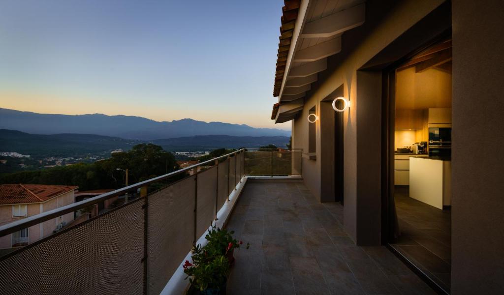 a balcony with a view of the mountains at Citta di Lume Suites &amp; Lofts in Porto-Vecchio