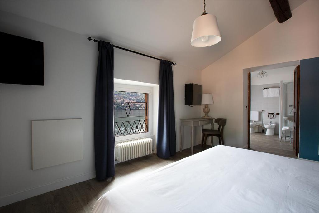 Postel nebo postele na pokoji v ubytování Hotel Orso Bruno