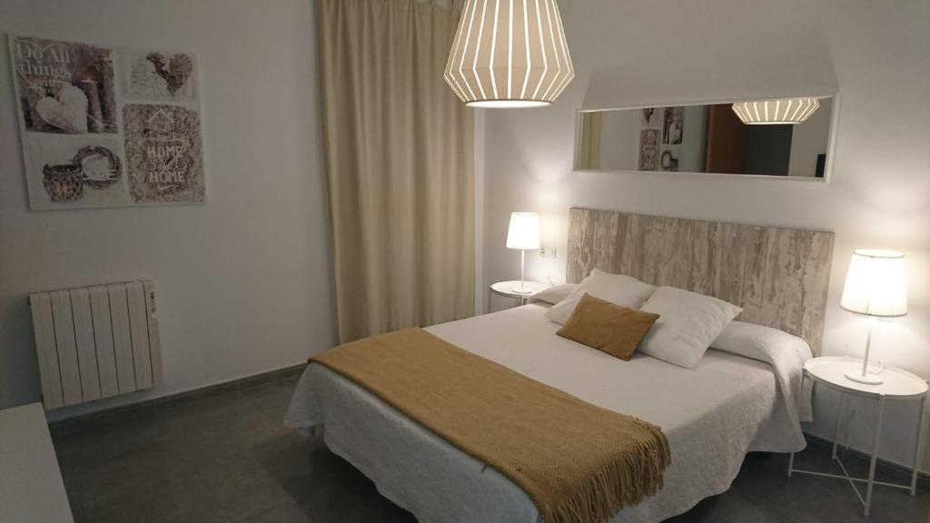 - une chambre avec un lit, 2 tables et 2 lampes dans l'établissement Playa y Montaña Faura-Valencia, à Faura