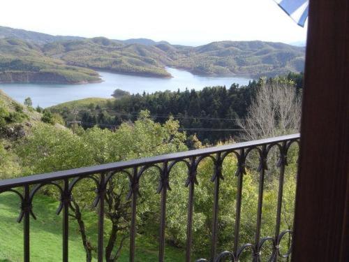 a balcony with a view of a body of water at Ersis in Neochori