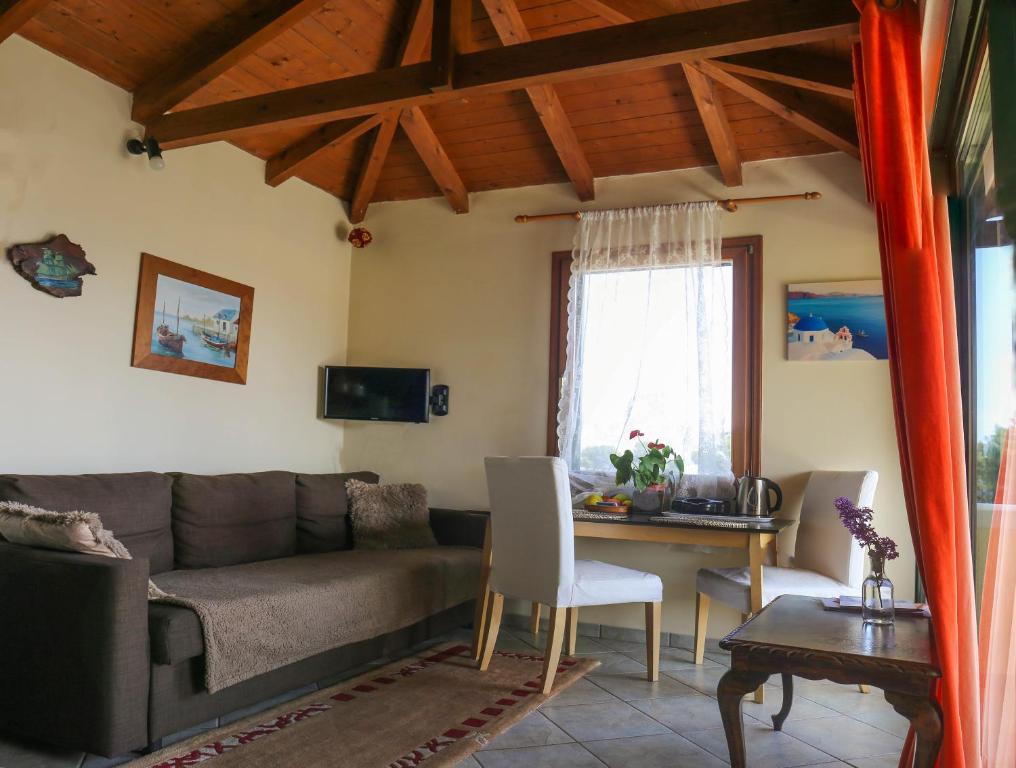 a living room with a couch and a table at Elena's House in Artemida