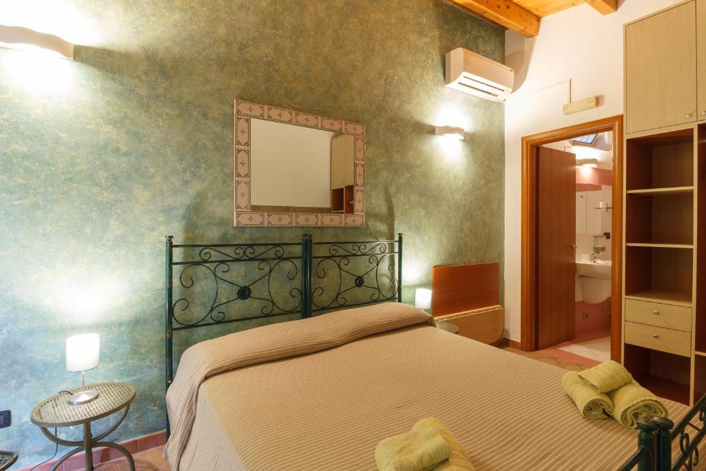Postel nebo postele na pokoji v ubytování Agriturismo Il Gelsomino Ritrovato