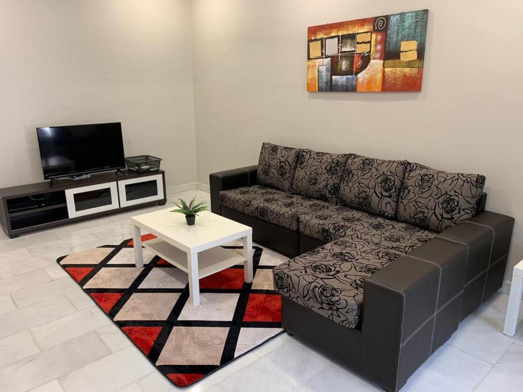 a living room with a couch and a table at AK Homestay in Port Dickson