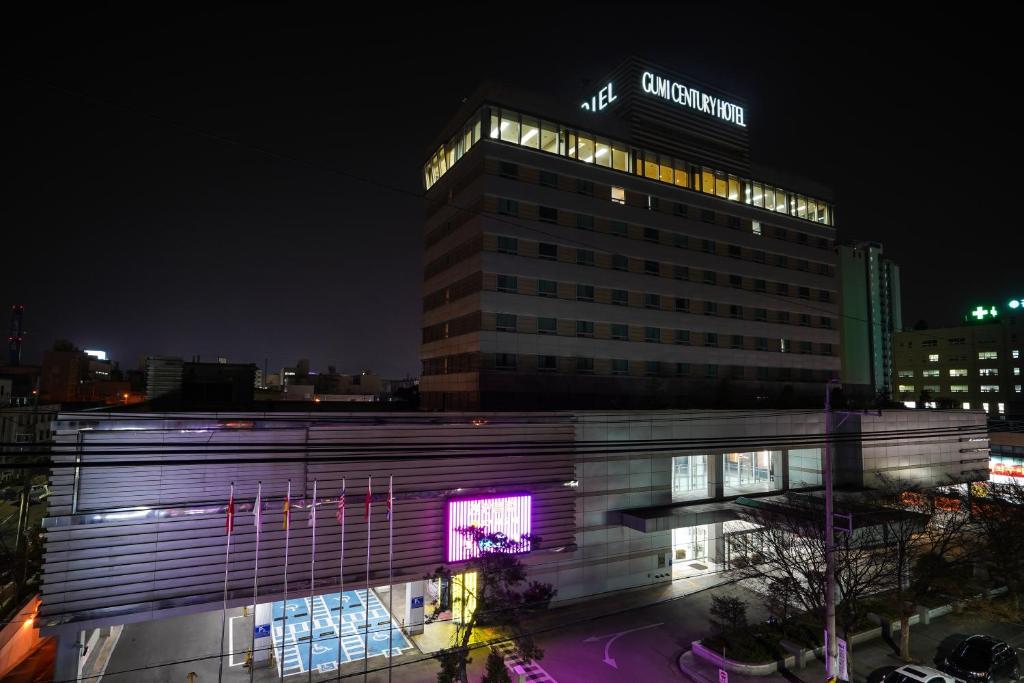 a building with a sign on the top of it at night at Gumi Century Hotel in Gumi