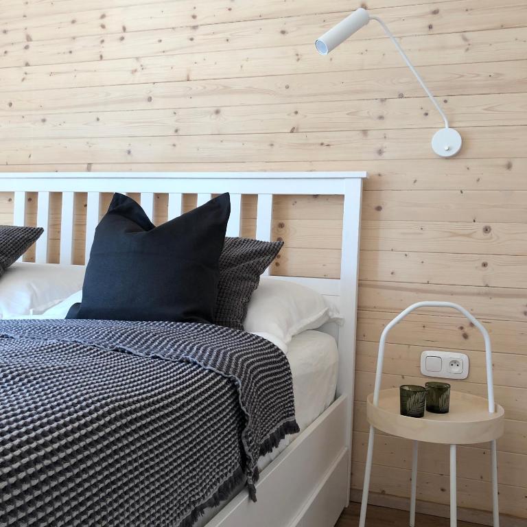 a bedroom with a white bed and a lamp at NORDIK 1496 in Vysoké Tatry