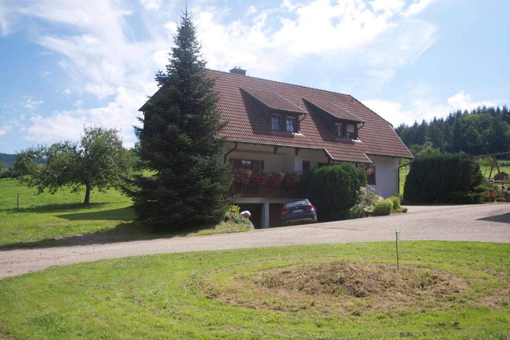 una casa con un árbol delante de una entrada en Ferienwohnung en Seelbach