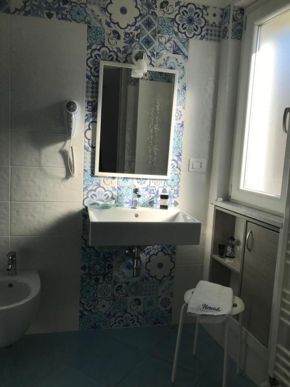 a bathroom with a sink and a mirror at Nereide in Tropea