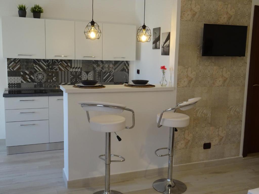 Kuchyň nebo kuchyňský kout v ubytování Holiday Rooms Portale Pirrera
