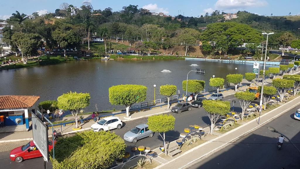 a view of a river with cars parked in a parking lot at HOTEL FLUMINENSE in Gandu