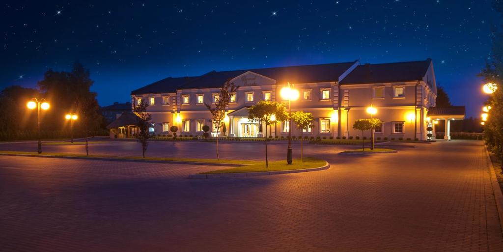 a large building at night with street lights at Dworek Eureka in Czechowice-Dziedzice