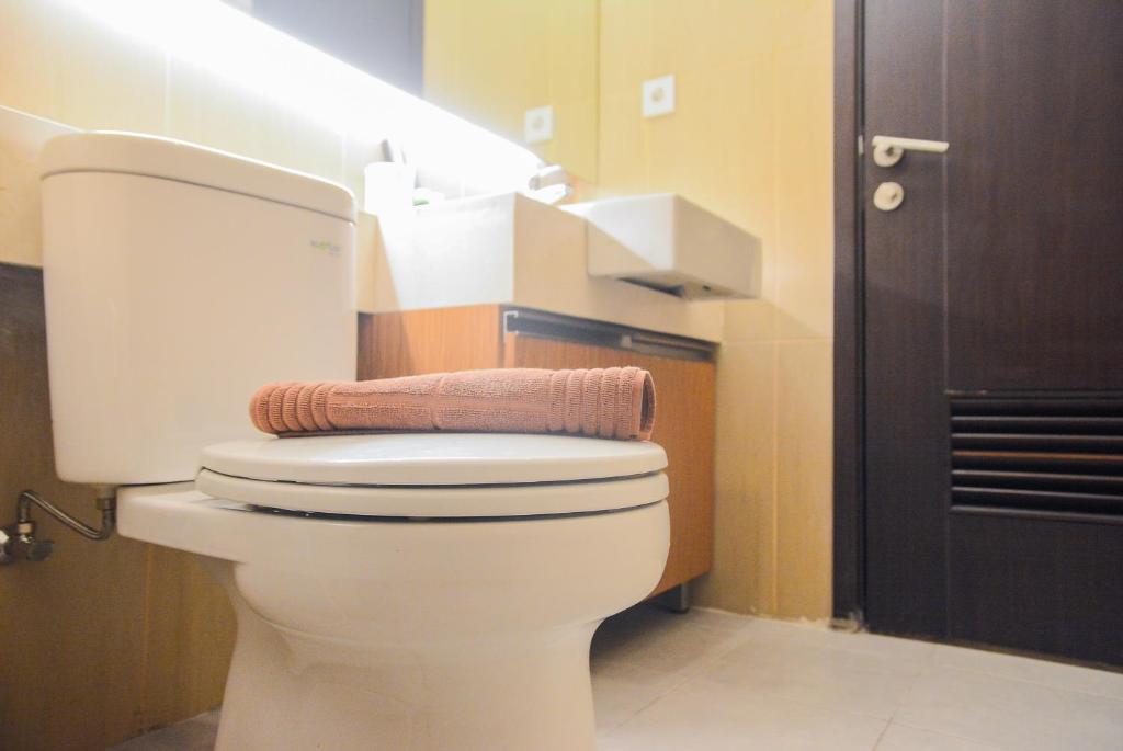 a bathroom with a white toilet in a room at Spacious 2BR GP Plaza Apartment By Travelio in Jakarta