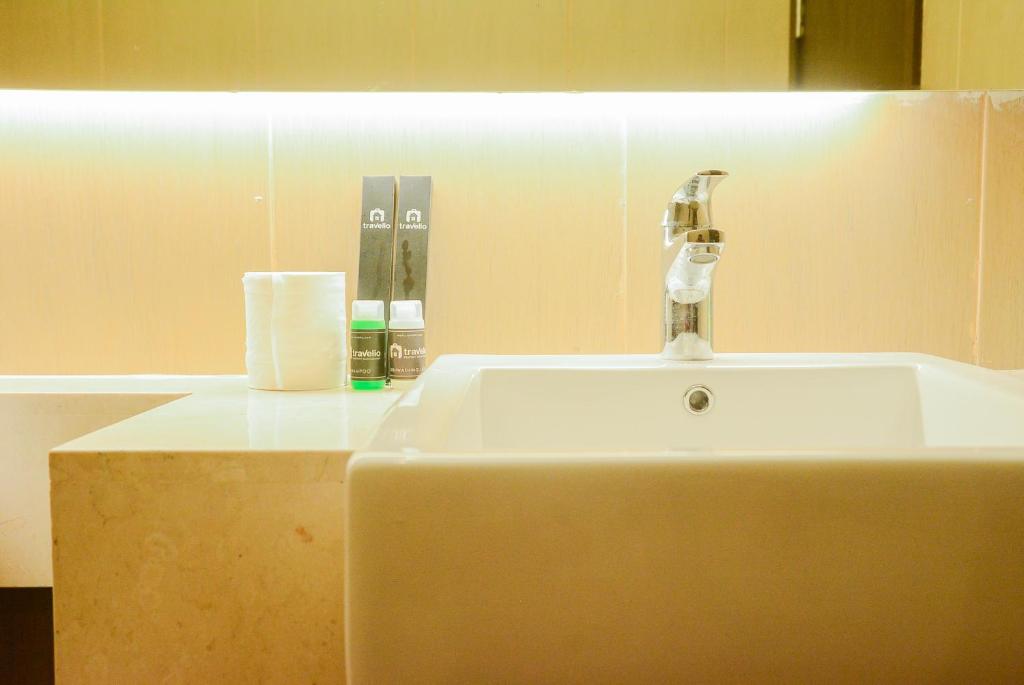 a bathroom sink with a faucet on top of it at Spacious 2BR GP Plaza Apartment By Travelio in Jakarta