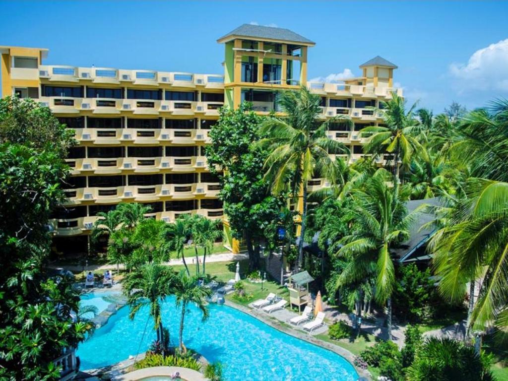 
a large building with palm trees and palm trees at Paradise Garden Resort Hotel & Convention Center in Boracay
