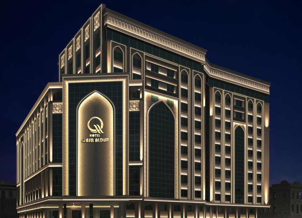 a building with a sign on the front of it at Qasr AlDur Hotel in An Najaf