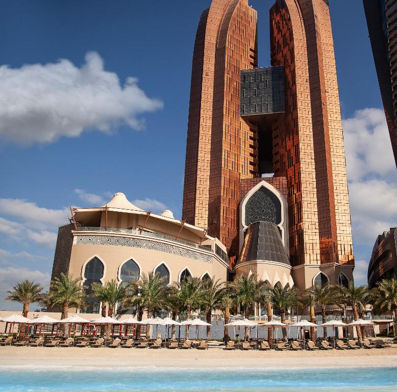 
a large building with a clock on top of it at Bab Al Qasr Hotel in Abu Dhabi
