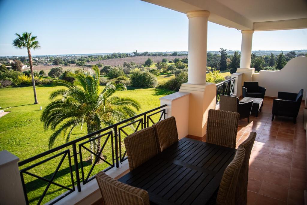 a balcony with a table and chairs and a view at Colina Verde Resort in Moncarapacho