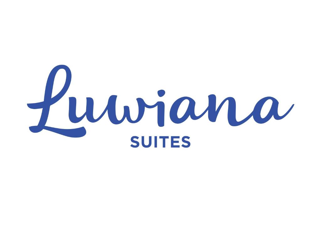a sign for the tupperware suites restaurant and hotel in fujairah at Luwiana Suites in Ljubljana