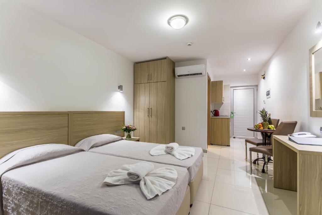 a bedroom with two white towels on a bed at Bellini Hotel in Ayia Napa
