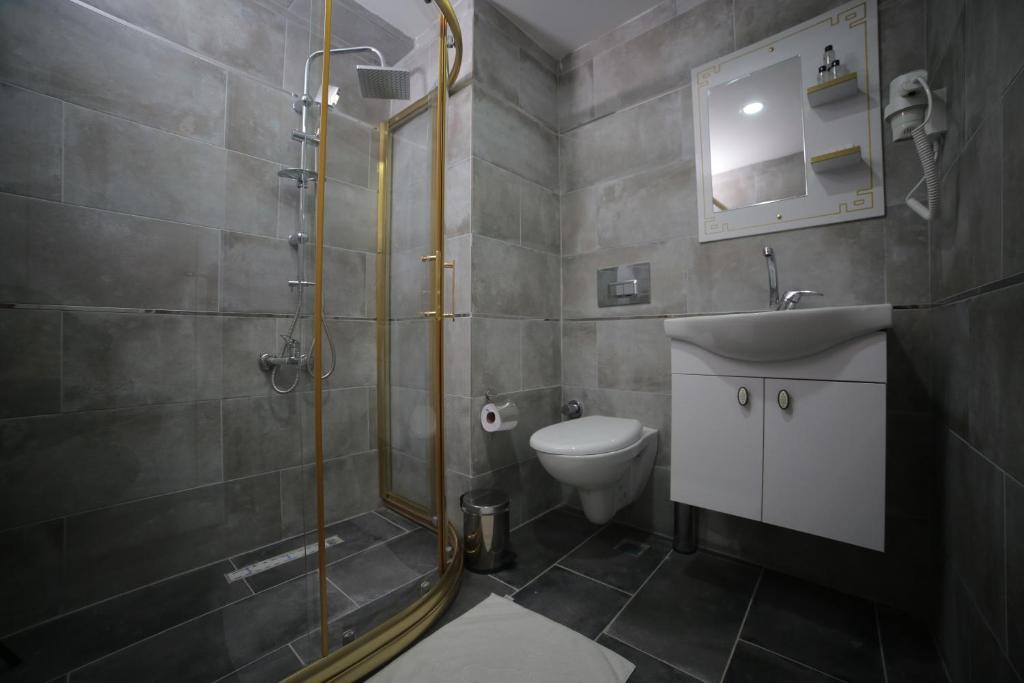 a bathroom with a shower and a sink and a toilet at Hotel Aksaray in Istanbul