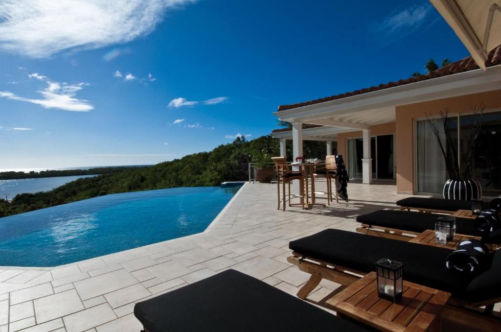 a patio with a swimming pool and a house at Dream Villa Terres Basses 543 in Les Terres Basses