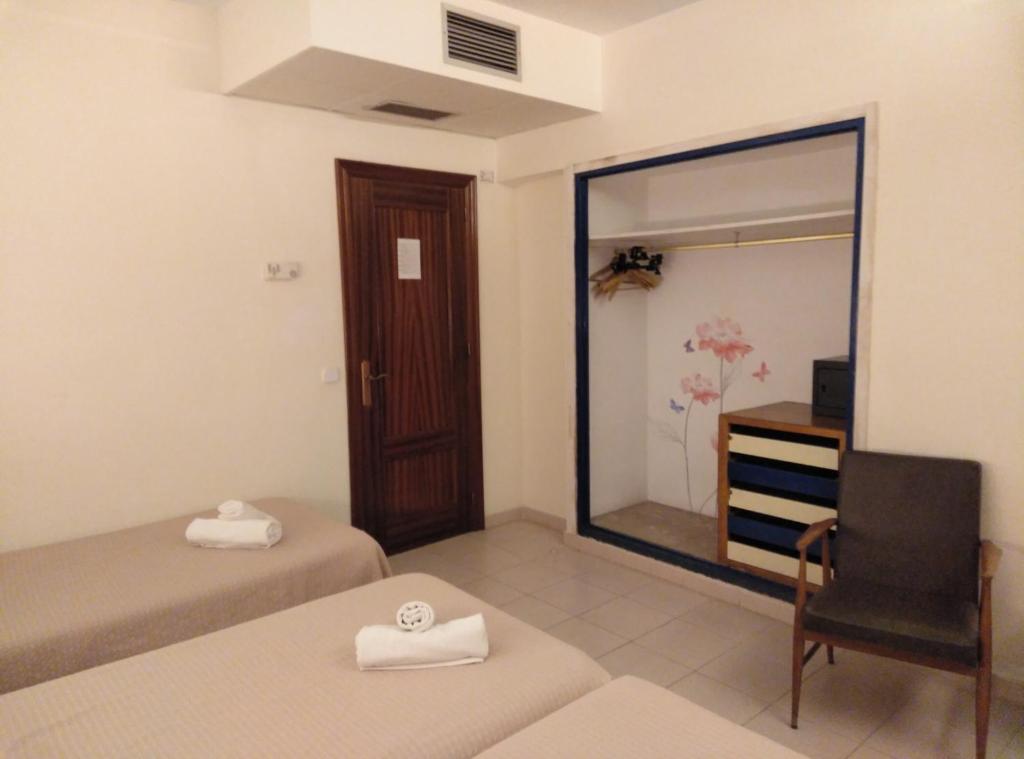 Postel nebo postele na pokoji v ubytování Hotel Corisco
