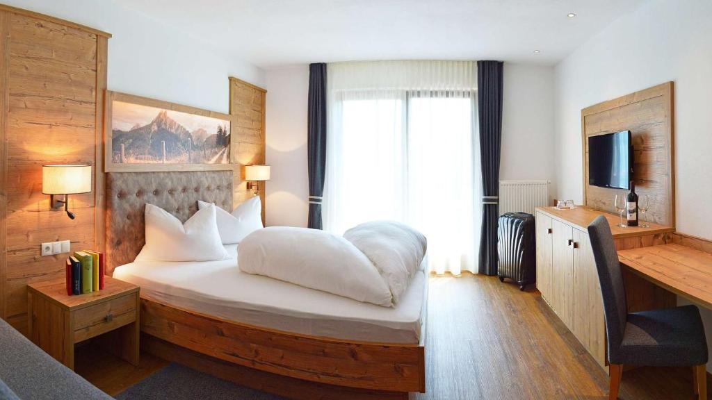 Postel nebo postele na pokoji v ubytování Hotel Trenker