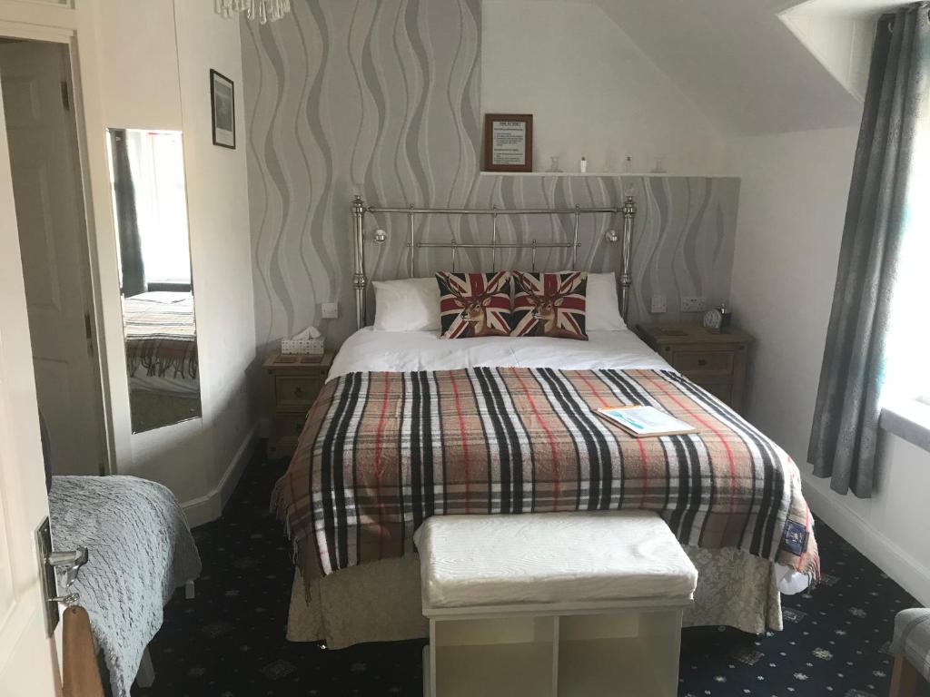 Postel nebo postele na pokoji v ubytování glenardran house