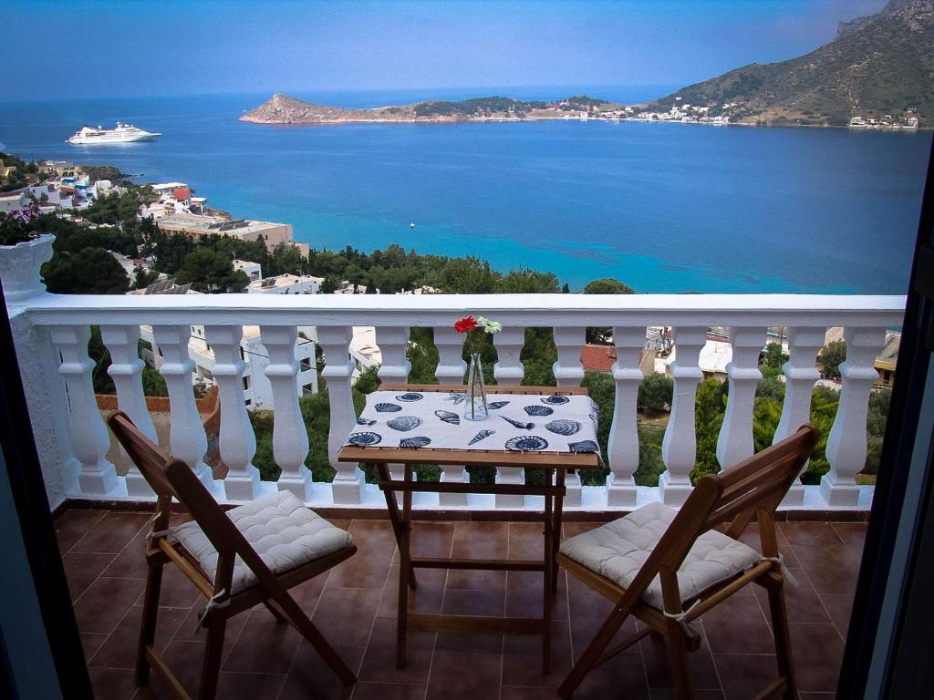 a table on a balcony with a view of the ocean at Panos Studios in Masouri